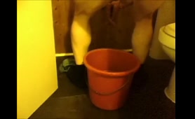 Lady craps in a bright orange container