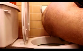 Hairy guy poops in toilet