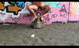 Woman Shits and Pisses on the Sand