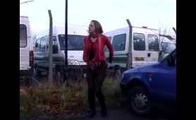 A Woman Craps in a Wet Parking Lot