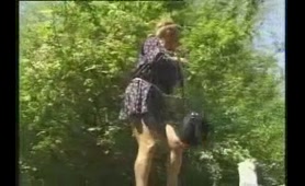 Woman pisses in the garden