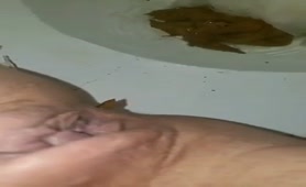 Shaved babe shitting in toilet