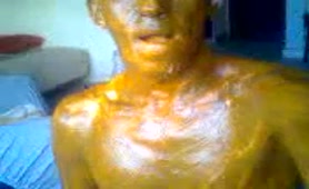Rubbing yellow shit on his entire body