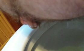 Mature man pooping a lot over the toilet